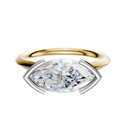 The 18K Two Tone Bezel Half Bezel East/West Cathedral Knife Edge 2.0mm Engagement Ring features an elegant design, displayed against a plain white background.