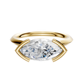 The 14K Yellow Gold Bezel Half Bezel East/West Cathedral Knife Edge 2.0mm Engagement Ring showcases a large marquise-cut diamond set horizontally with prongs, displayed on a plain white background.