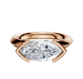 An 18K rose gold East/West cathedral knife edge engagement ring with a half bezel setting and a 3.0mm geometric-cut clear diamond, displayed on a plain white background.