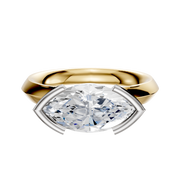 An 18K two-tone engagement ring with a 3.0mm knife-edge band, featuring an east/west cathedral design and half bezel setting for a modern look.