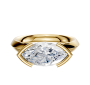 An 18K yellow gold Cathedral knife edge engagement ring with a 3.0mm marquise-cut diamond in an east/west half bezel setting, accented by four gold prongs, shown on a plain white background.