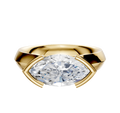 An 18K yellow gold engagement ring with a wide, cathedral knife edge band, showcasing a 4.0mm clear stone in an east/west half bezel setting for a modern look.