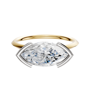 An 18K Two Tone Bezel Half Bezel East/West Classic Knife Edge 1.5mm engagement ring with a large oval diamond is displayed on a plain white background.