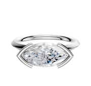 A Platinum Bezel Half Bezel East/West Classic Knife Edge 2.0mm Engagement Ring is shown, featuring a horizontally-set diamond in a sleek modern setting against a plain white background.