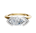 A 14K two-tone engagement ring featuring a classic knife edge and an east/west oval diamond in a distinctive half bezel setting.