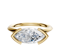 The 14K Yellow Gold Bezel Half Bezel East/West Classic Knife Edge 2.0mm Engagement Ring features a horizontally set gemstone in a sleek gold setting, shown against a plain white background.