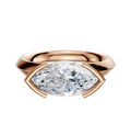 A 14K rose gold engagement ring with a classic knife edge 3.0mm band in a half bezel east/west setting, shown against a plain white background.