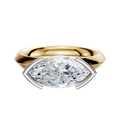 An 18K two-tone engagement ring with a classic knife-edge band and a half bezel east/west setting, featuring a marquise-cut diamond, displayed against a plain white background.