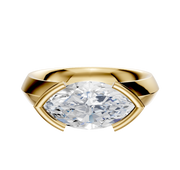 An 18K yellow gold engagement ring features a 4.0mm diamond set east/west in a classic knife edge half bezel band with modern geometric prongs. Displayed against a plain white background.