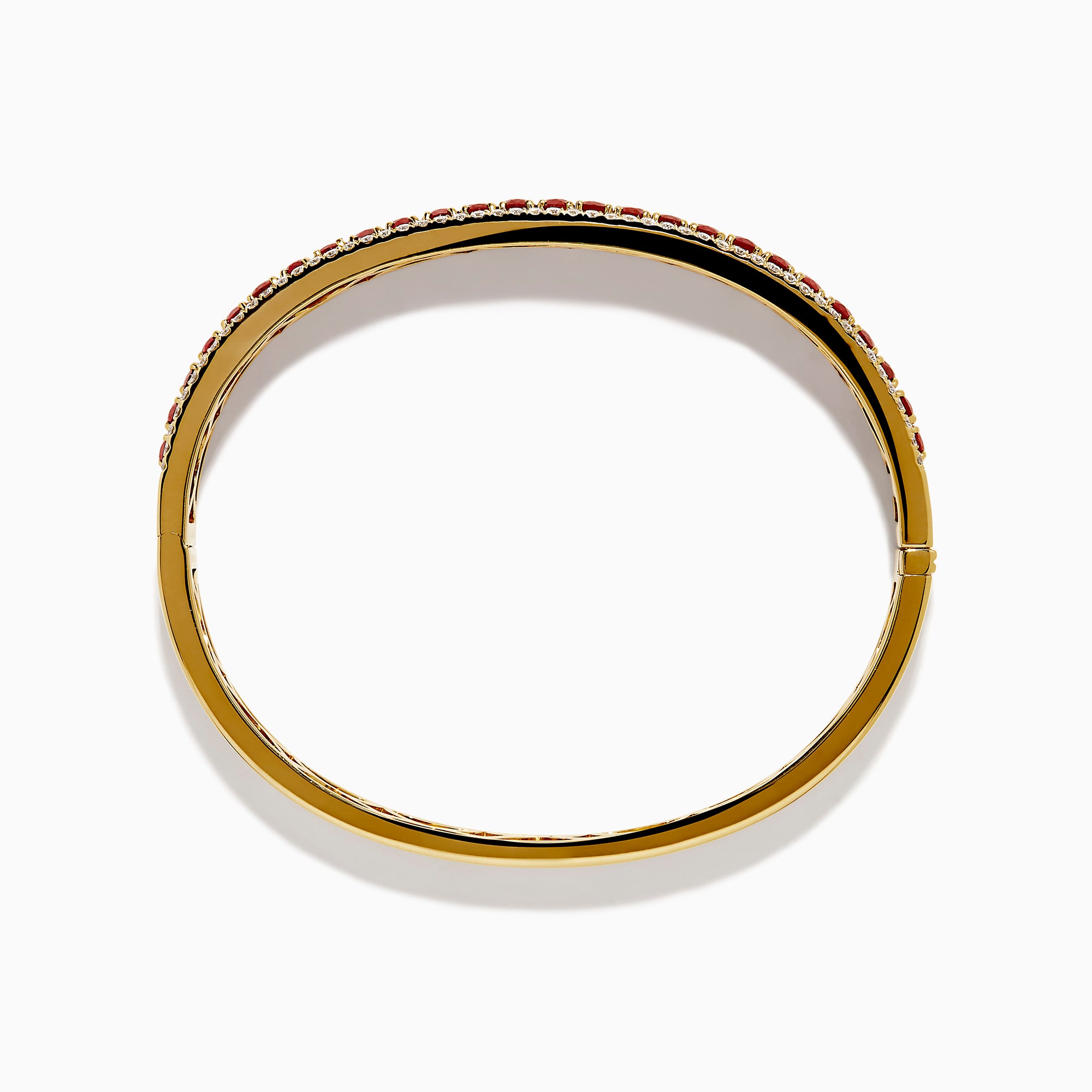 The 18K Yellow Gold Ruby and Diamond Bangle features a honeycomb-patterned interior, with a row of rubies bordered by two rows of sparkling diamonds on the outside.