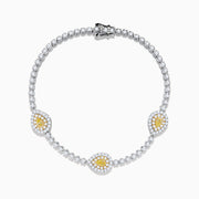 The 18K Two Tone Gold Yellow and White Diamond Bracelet features alternating round white stones and three central yellow diamond clusters, each encircled by white diamonds, secured with a reliable clasp.