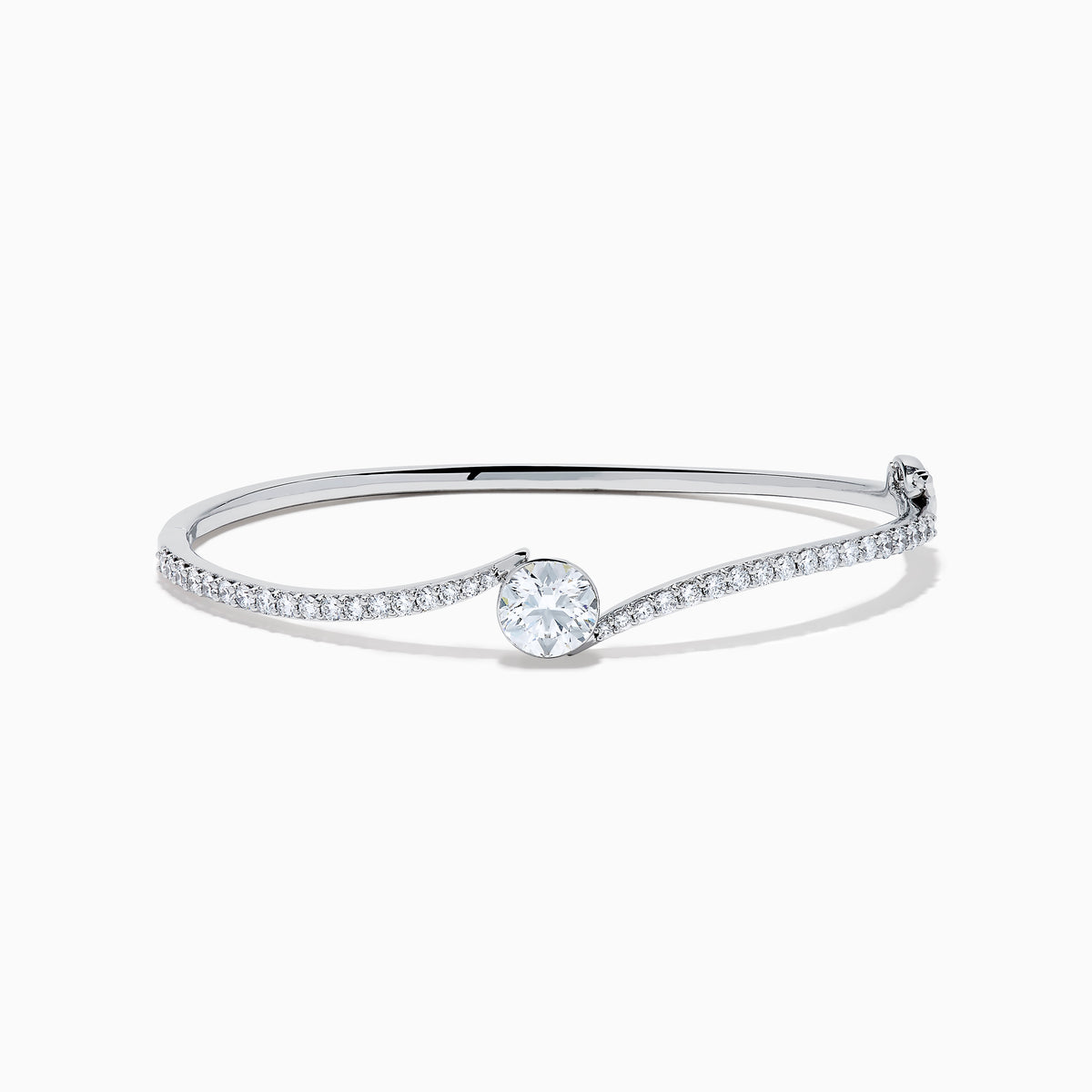 The Star Lab Grown Diamond Connect Bangle in 18K White Gold features a central round lab-grown diamond and a band set with small diamonds, all in an elegantly curved design, displayed on a white background.