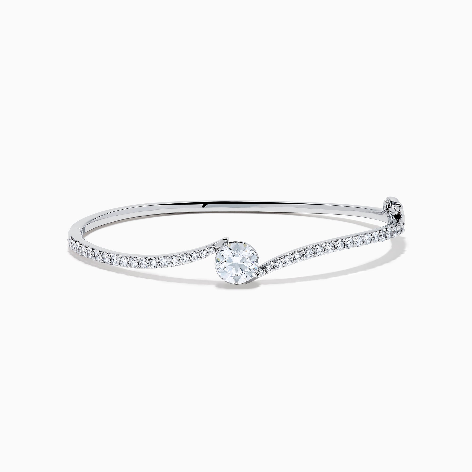 The Star Lab Grown Diamond Connect Bangle in 18K White Gold features a central round lab-grown diamond and a band set with small diamonds, all in an elegantly curved design, displayed on a white background.