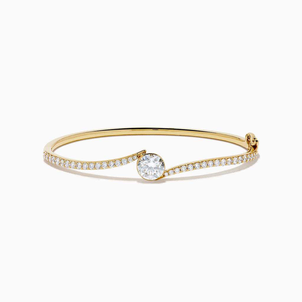 The Star Lab Grown Diamond Connect Bangle in 18K Yellow Gold features a central Star Lab Diamond with a row of smaller diamonds on an angled band, shown against a white background.