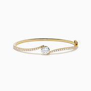The Star Lab Grown Diamond Connect Bangle in 18K Yellow Gold features a central Star Lab Diamond with a row of smaller diamonds on an angled band, shown against a white background.