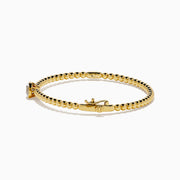 The Star Lab Grown Diamond Beaded Bangle in 18K Yellow Gold features a delicate gold band with beaded accents and a single round, clear lab-grown diamond at the center, shown against a plain white background.