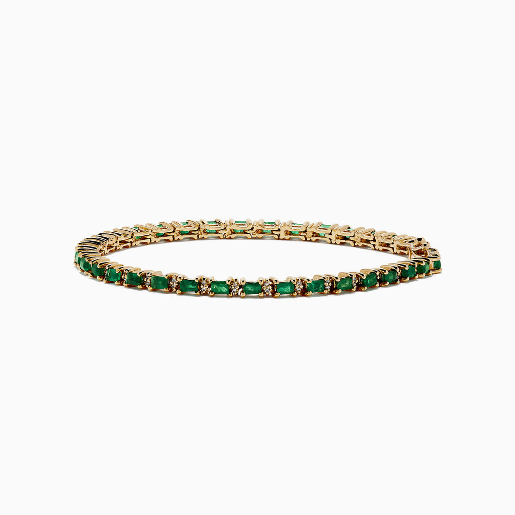 The Brasilica 14K Yellow Gold Emerald and Diamond Tennis Bracelet features a row of green emeralds and sparkling diamonds set in yellow gold prongs, shown against a plain white background.