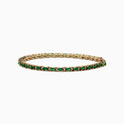 The Brasilica 14K Yellow Gold Emerald and Diamond Tennis Bracelet features a row of green emeralds and sparkling diamonds set in yellow gold prongs, shown against a plain white background.
