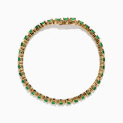 The Brasilica 14K Yellow Gold Emerald and Diamond Tennis Bracelet features a row of green emeralds and sparkling diamonds set in yellow gold prongs, shown against a plain white background.