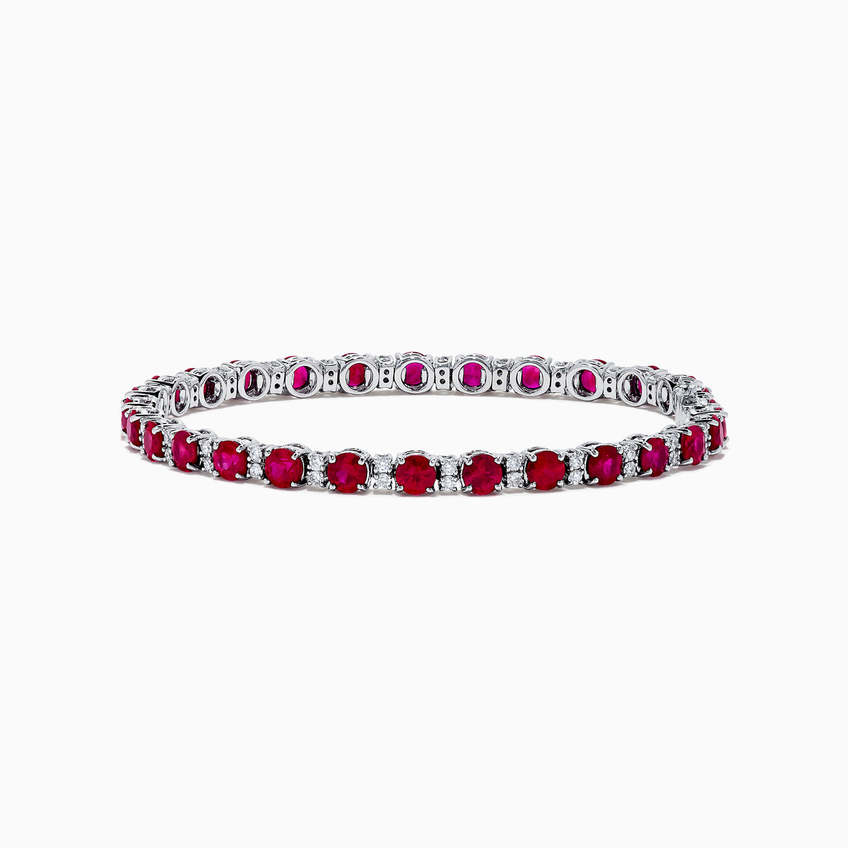 The Ruby Royale 18K White Gold Ruby and Diamond Tennis Bracelet showcases vibrant red rubies in individual prong settings, elegantly displayed against a plain white background.