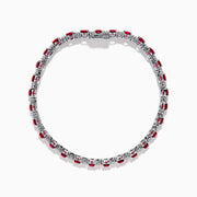 The Ruby Royale 18K White Gold Ruby and Diamond Tennis Bracelet showcases vibrant red rubies in individual prong settings, elegantly displayed against a plain white background.