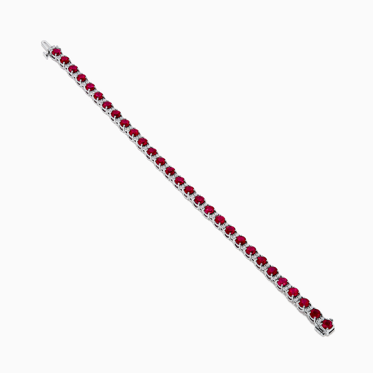 The Ruby Royale 18K White Gold Ruby and Diamond Tennis Bracelet showcases vibrant red rubies in individual prong settings, elegantly displayed against a plain white background.