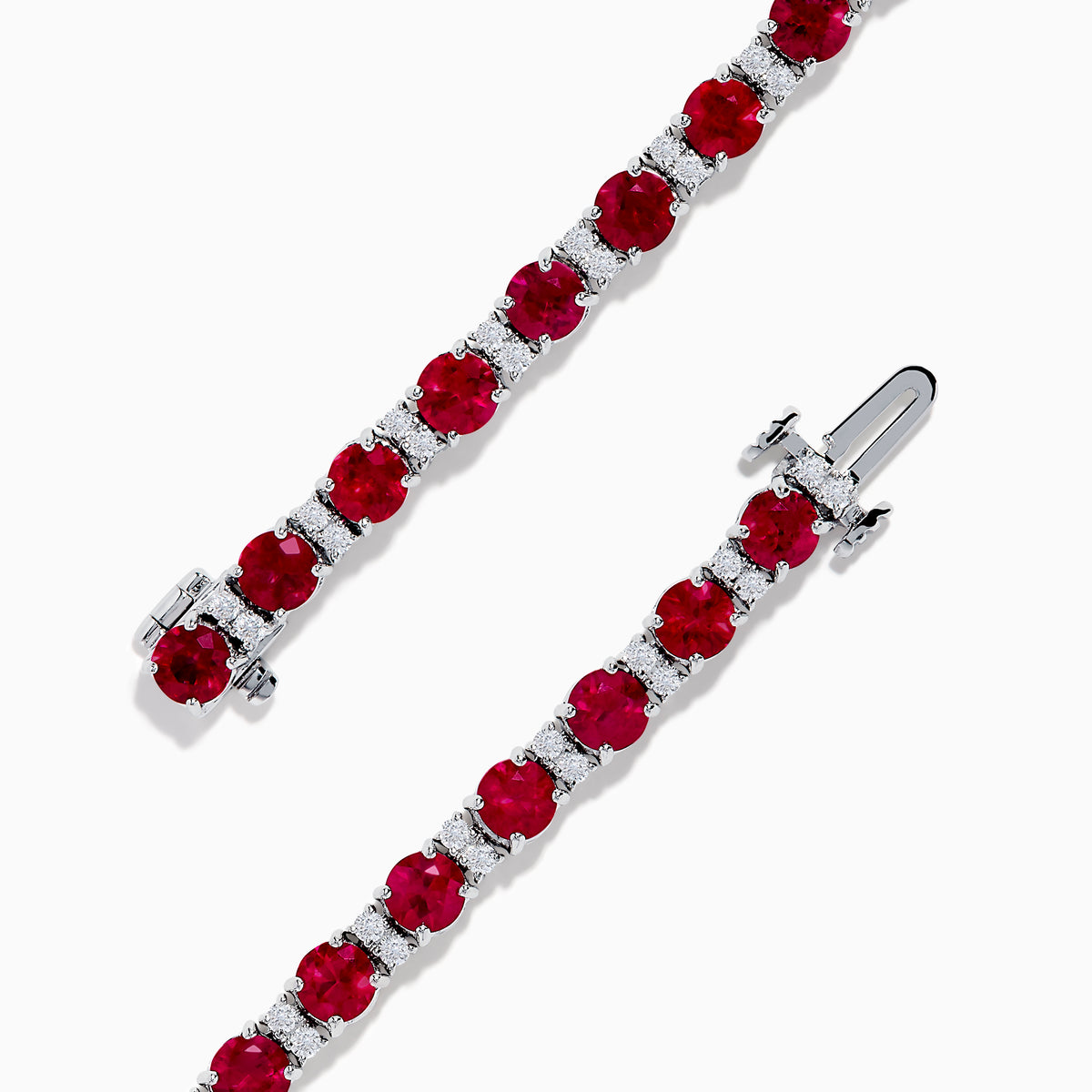 The Ruby Royale 18K White Gold Ruby and Diamond Tennis Bracelet showcases vibrant red rubies in individual prong settings, elegantly displayed against a plain white background.