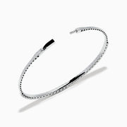 The 14K White Gold Flexible Diamond Bracelet features a slim, elegant design with a single row of sparkling diamonds set around its flexible band, shown against a white background.