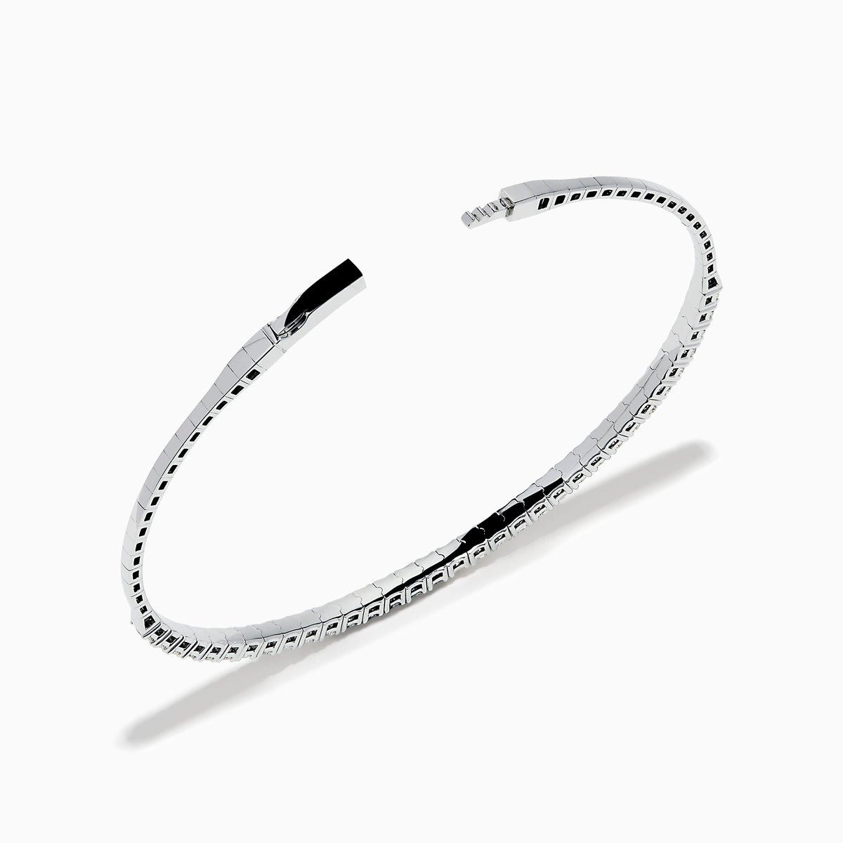 The 14K White Gold Flexible Diamond Bracelet features a slim, elegant design with a single row of sparkling diamonds set around its flexible band, shown against a white background.
