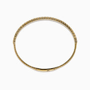The 14K Yellow Gold Flexible Diamond Bracelet showcases a row of white diamonds on its outer surface, elegantly displayed against a plain white background.