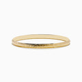 The 14K Yellow Gold Chevron Bangle features a subtle engraved pattern along its outer surface and is displayed on a white background.