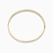 The 14K Yellow Gold Chevron Bangle features a subtle engraved pattern along its outer surface and is displayed on a white background.
