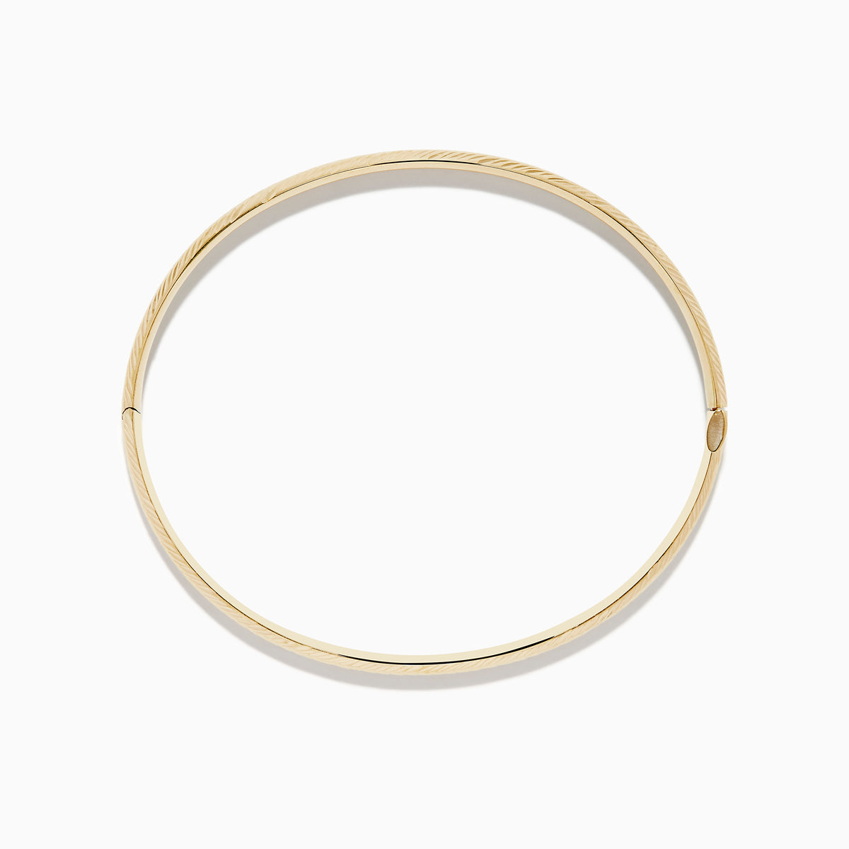The 14K Yellow Gold Chevron Bangle features a subtle engraved pattern along its outer surface and is displayed on a white background.