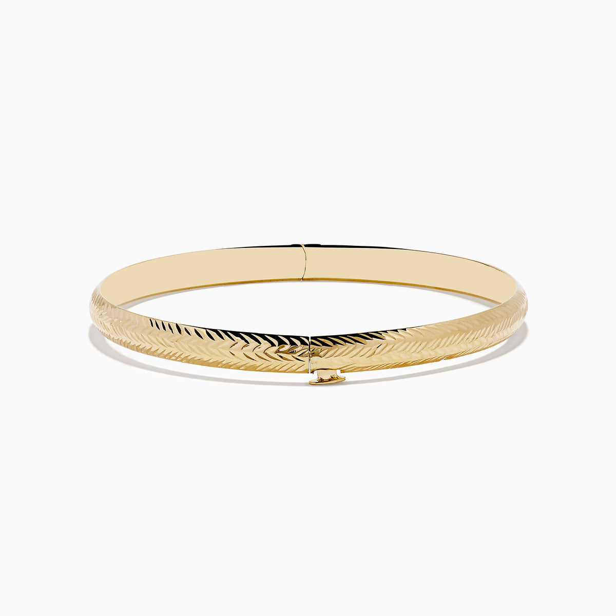 The 14K Yellow Gold Chevron Bangle features a subtle engraved pattern along its outer surface and is displayed on a white background.