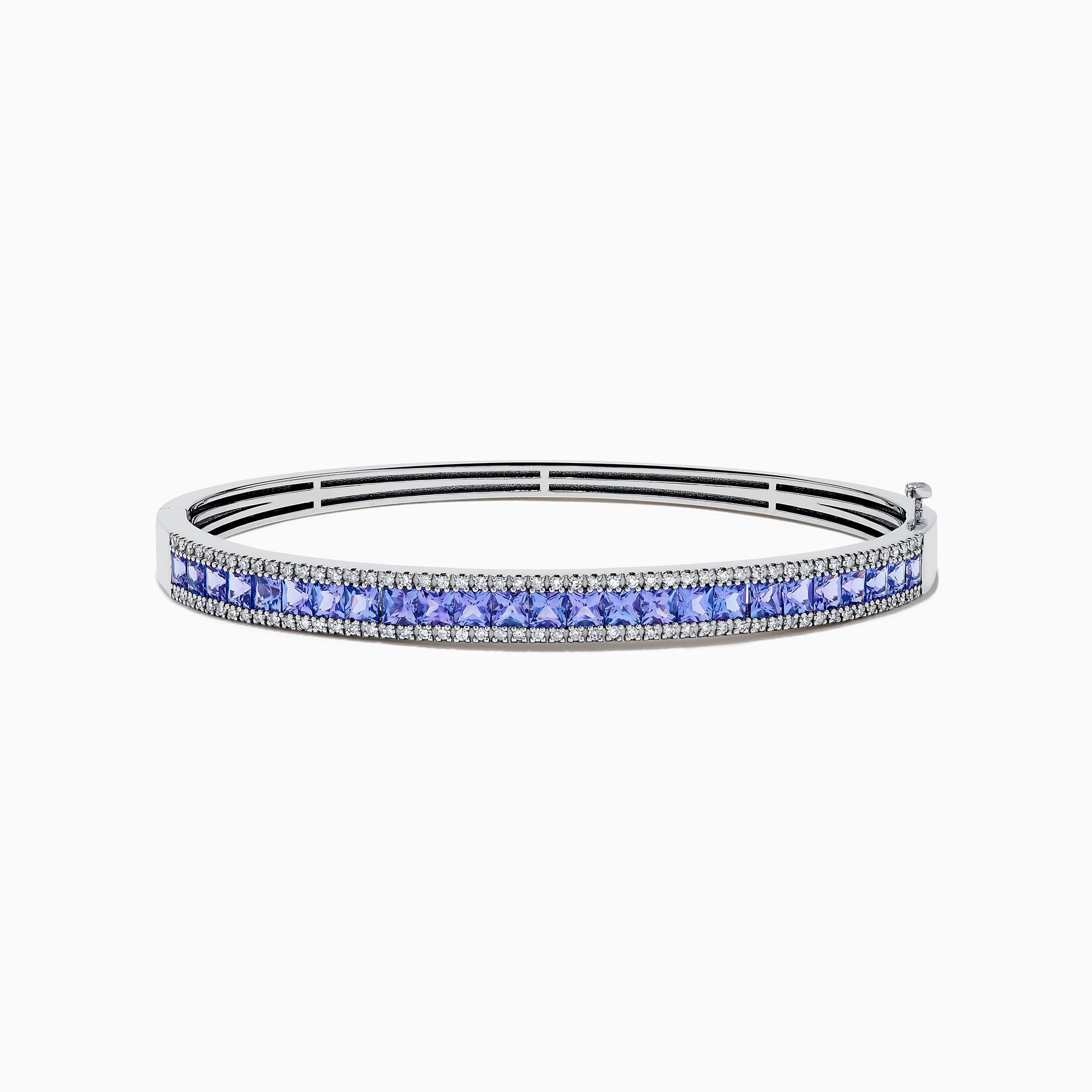 The Nahla Siri 14K White Gold Tanzanite and Diamond Bangle showcases a row of square-cut blue tanzanites between two rows of sparkling diamonds, elegantly displayed against a white backdrop.