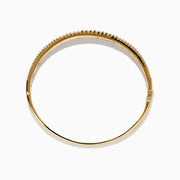 The Ruby Royale 14K Yellow Gold Ruby and Diamond Bangle features two rows of sparkling diamonds flanking a central row of square-cut rubies for a symmetrical, elegant design.