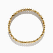 The D'Oro 14K Yellow Gold Diamond Stretch Bracelet features rounded beads and a central row of sparkling diamonds in a symmetrical, elegant design.
