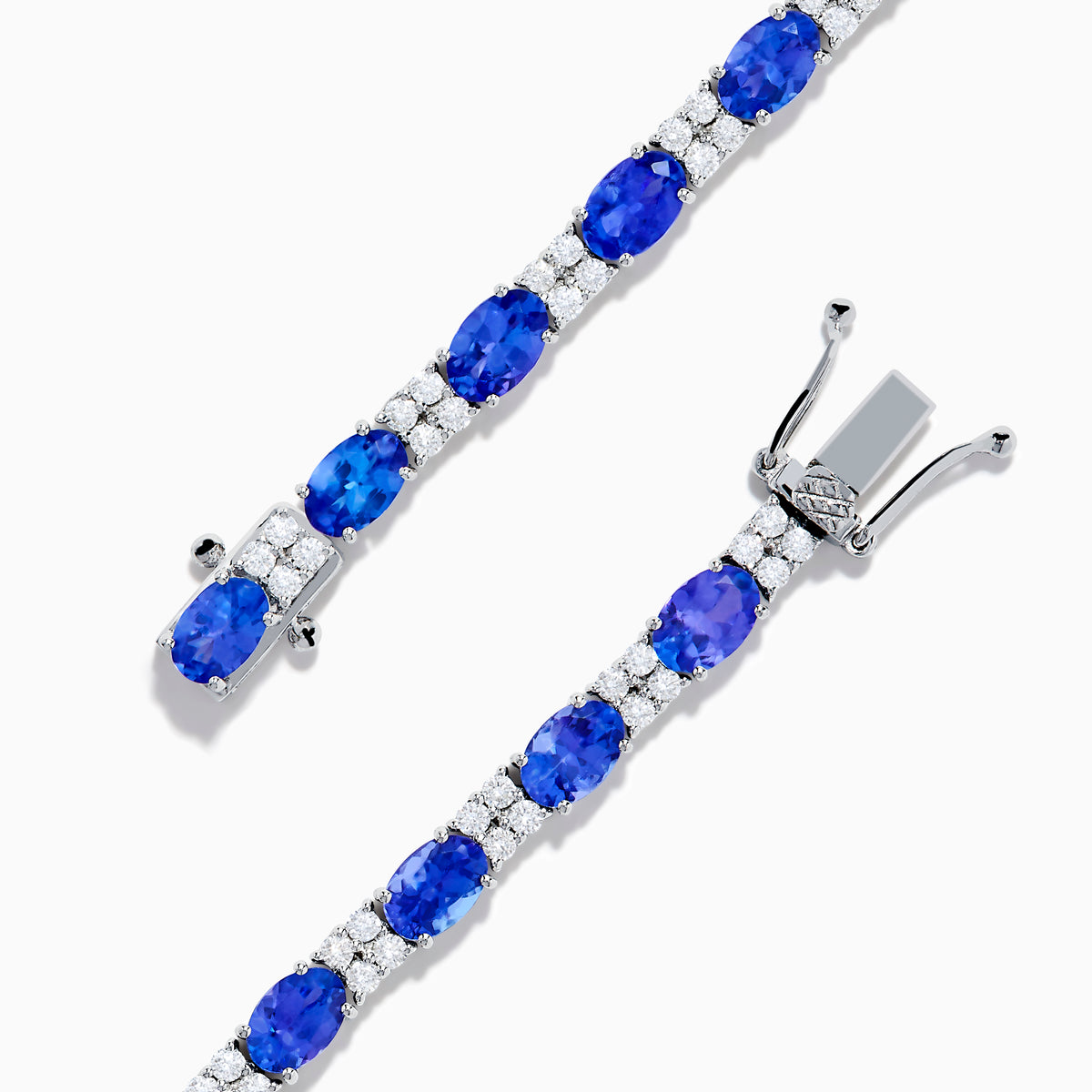 The 14K White Gold Tanzanite and Diamond Tennis Bracelet features alternating oval tanzanite gemstones and sparkling diamonds set against a plain white background.