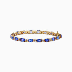 The 14K Yellow Gold Tanzanite and Diamond Tennis Bracelet showcases alternating round blue tanzanites and sparkling diamonds in a single row, secured with a reliable clasp.