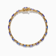 The 14K Yellow Gold Tanzanite and Diamond Tennis Bracelet showcases alternating round blue tanzanites and sparkling diamonds in a single row, secured with a reliable clasp.