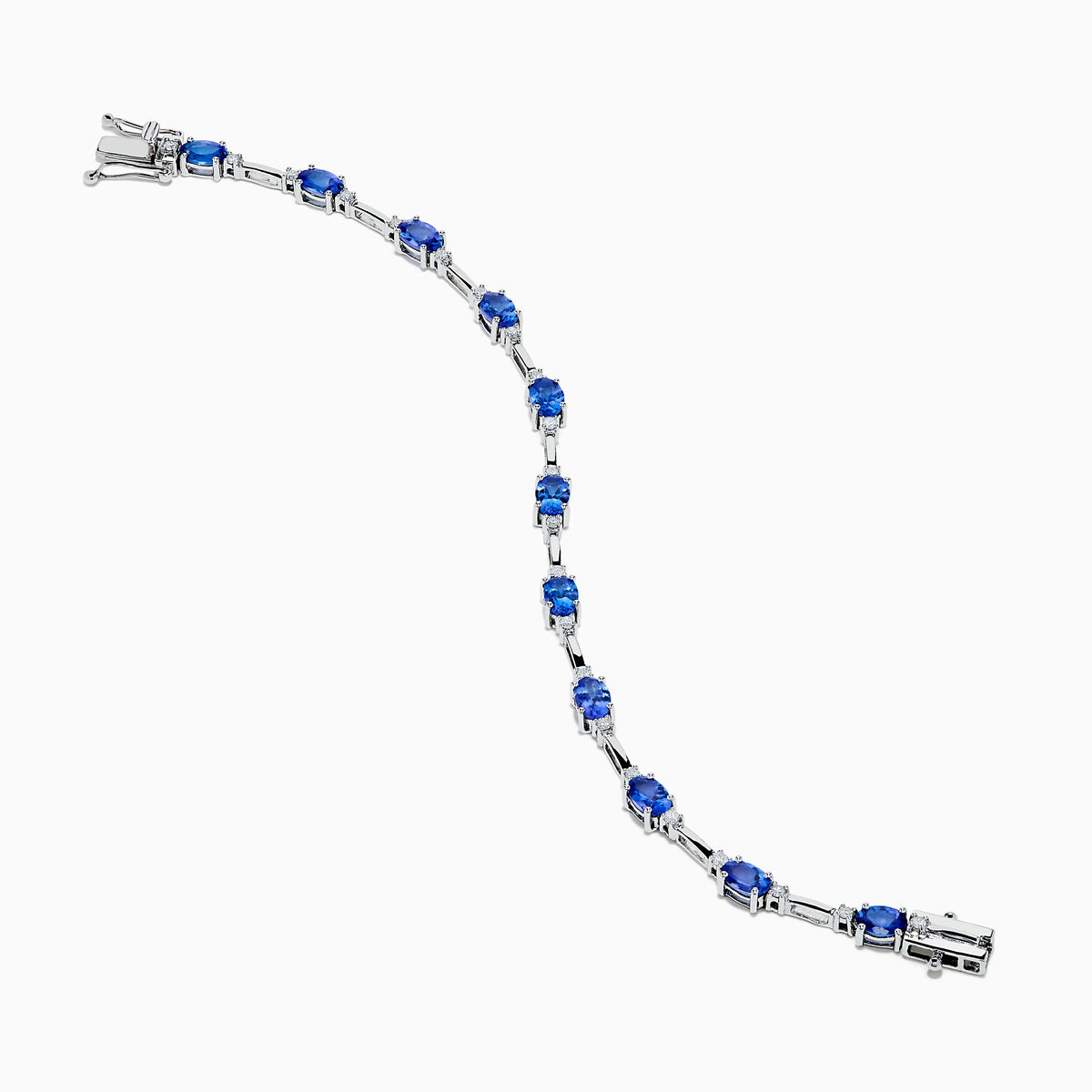 The 14K White Gold Tanzanite and Diamond Station Bracelet features vibrant oval-cut tanzanites and sparkling diamonds evenly spaced along the band, connected by delicate links for a timeless, elegant look.