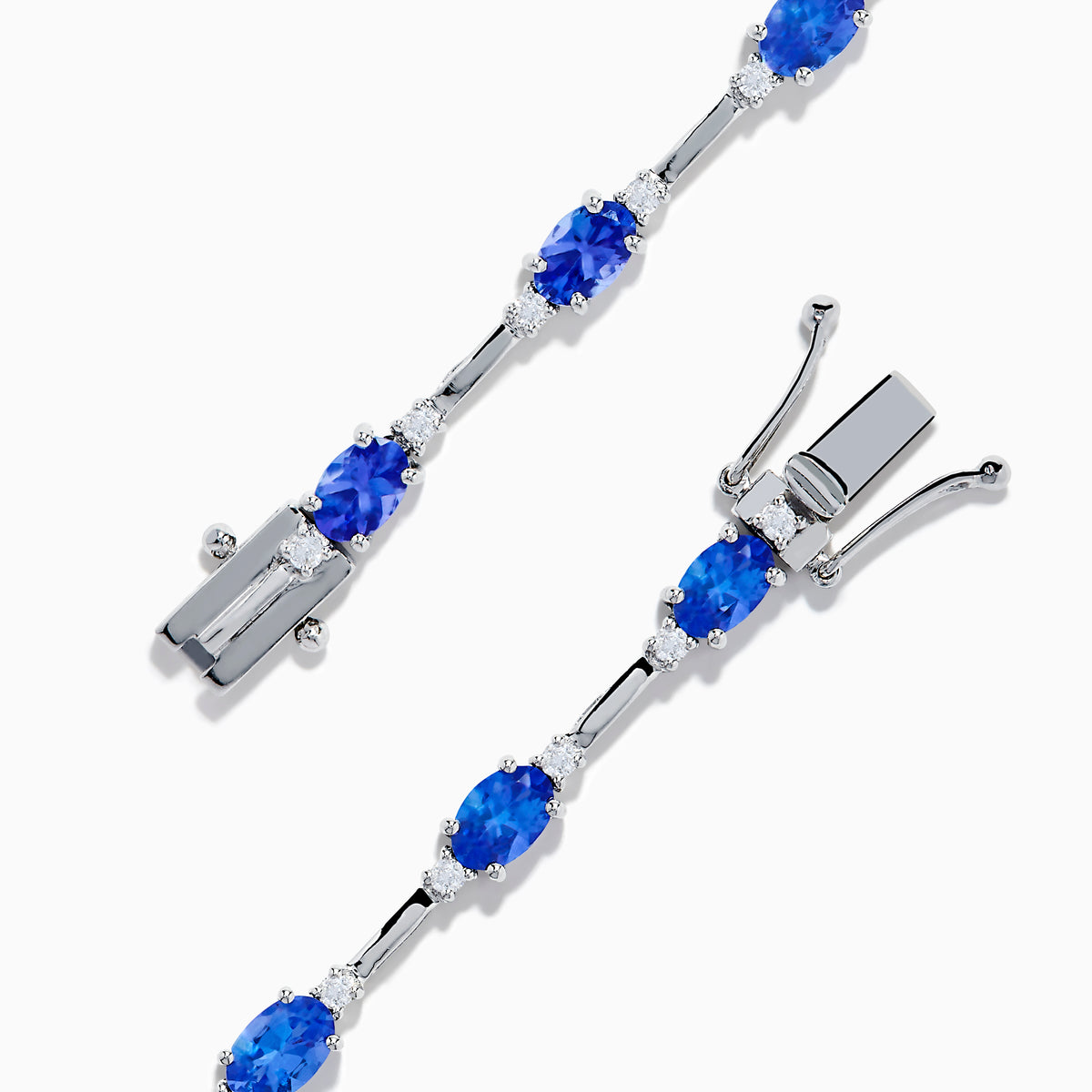 The 14K White Gold Tanzanite and Diamond Station Bracelet features vibrant oval-cut tanzanites and sparkling diamonds evenly spaced along the band, connected by delicate links for a timeless, elegant look.