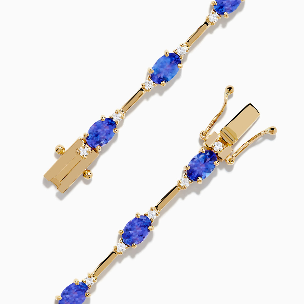 The 14K Yellow Gold Tanzanite and Diamond Station Bracelet showcases evenly spaced oval tanzanites set in gold links, each accented by sparkling diamonds, creating an elegant look against a white background.