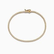 The 14K Yellow Gold Diamond Tennis Bracelet 1.30 TCW features a single row of round white diamonds in prong settings, displayed in a circular shape on a white background.