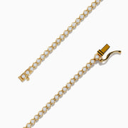 The 14K Yellow Gold Diamond Tennis Bracelet 1.30 TCW features a single row of round white diamonds in prong settings, displayed in a circular shape on a white background.