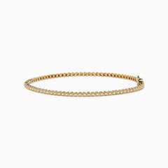 The 14K Yellow Gold 0.25 Ct. Diamond Tennis Bracelet features small, evenly spaced round diamonds and is displayed on a white background.