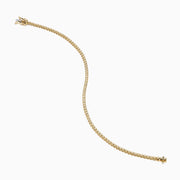 The 14K Yellow Gold 0.25 Ct. Diamond Tennis Bracelet features small, evenly spaced round diamonds and is displayed on a white background.
