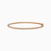 The 14K Rose Gold 0.25 Ct. Diamond Tennis Bracelet features a continuous row of sparkling round-cut diamonds, elegantly photographed on a white background.