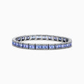 The Nahla Siri 14K White Gold Tanzanite and Diamond Tennis Bracelet features square blue tanzanites bordered by sparkling diamonds, elegantly set in a classic tennis bracelet design.
