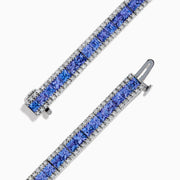 The Nahla Siri 14K White Gold Tanzanite and Diamond Tennis Bracelet features square blue tanzanites bordered by sparkling diamonds, elegantly set in a classic tennis bracelet design.